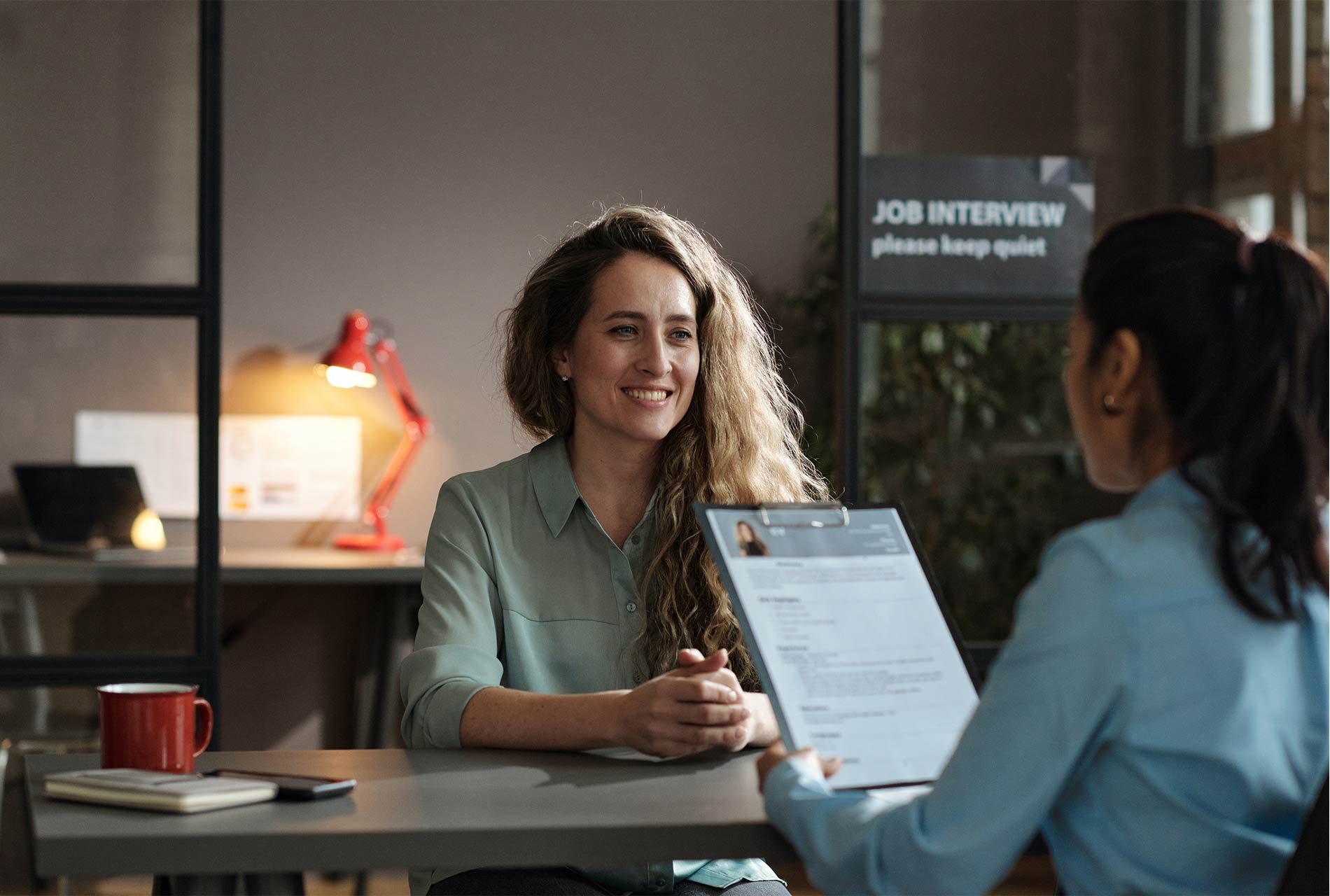 HR consultant reviewing a candidate CV during an interview