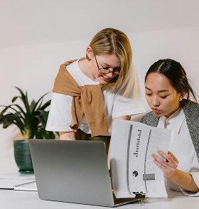 Two colleagues reviewing HR documents together